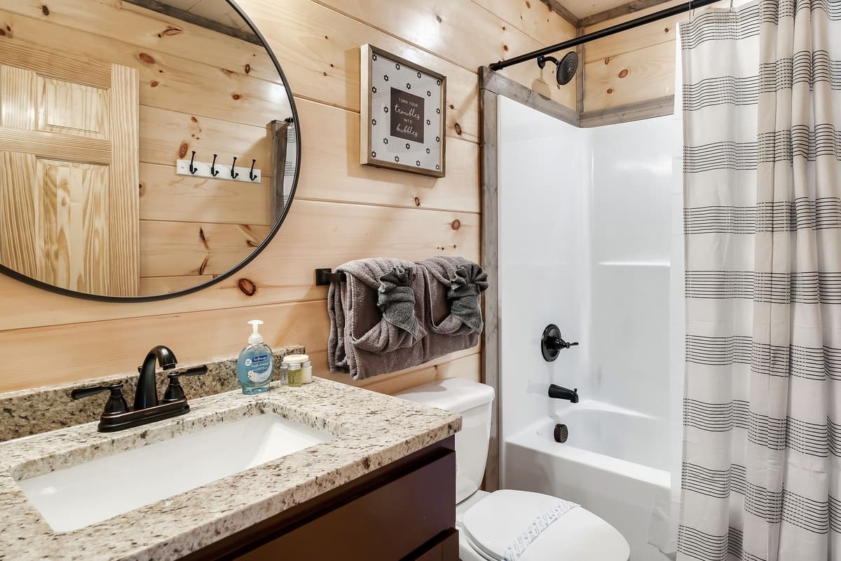 Freshen up and unwind in a comfortable bathroom featuring a convenient shower-and-tub combination.