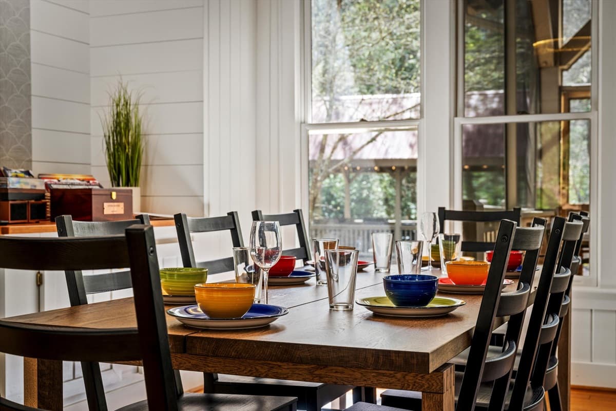 Dining Room Table Set for a Meal with Colorful Tableware and Natural Light