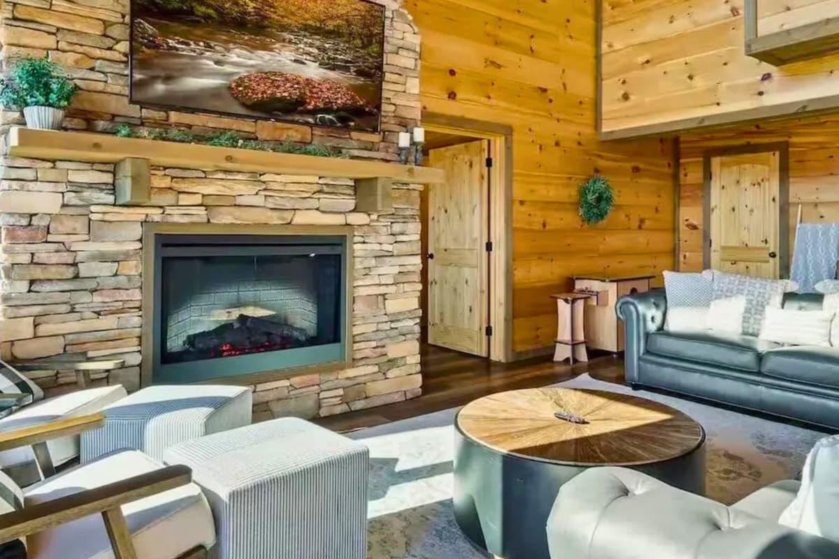 Settle into the cozy living area, where a warm fireplace and TV create the perfect spot to unwind.