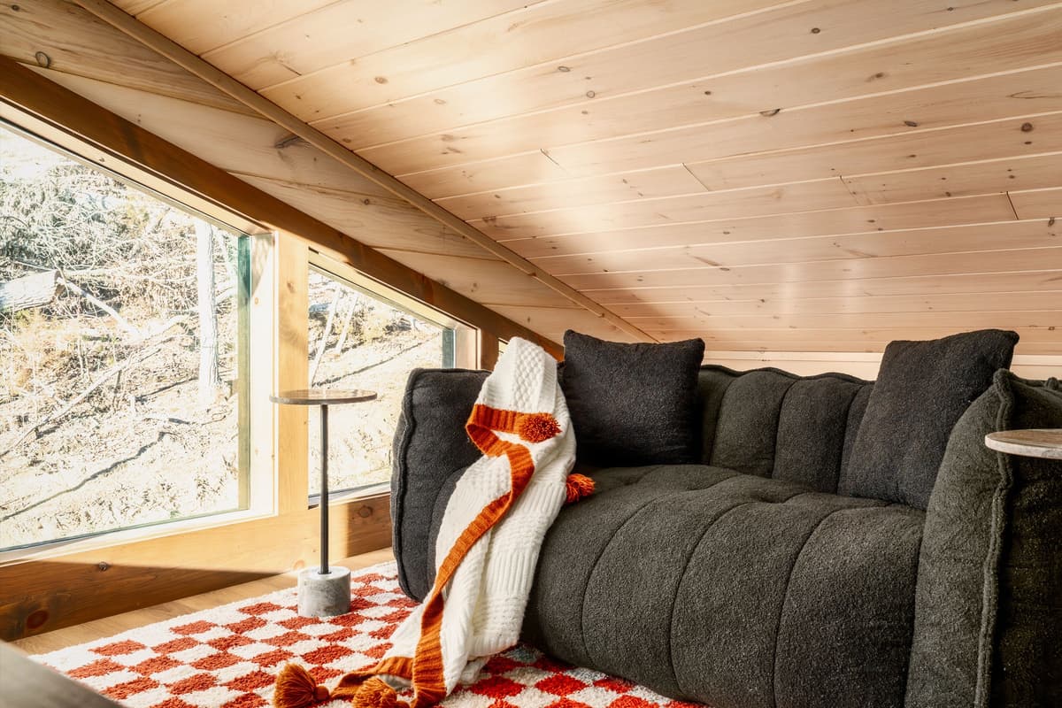 Relax and settle into the upstairs TV room, furnished with a comfortable sofa that’s perfect for stretching out after a day of Smoky Mountain adventures.
