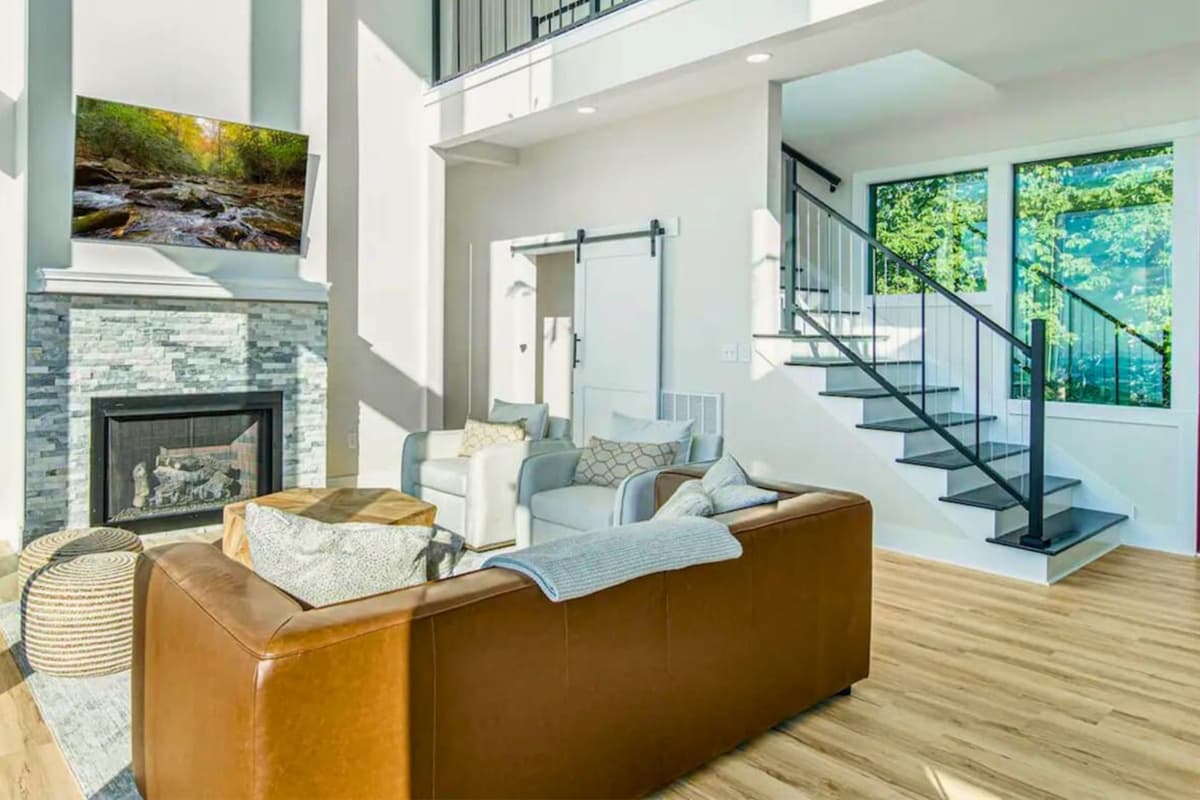 Relax in the bright, open-concept living space, featuring large windows that fill the room with natural light and create a warm, inviting atmosphere.