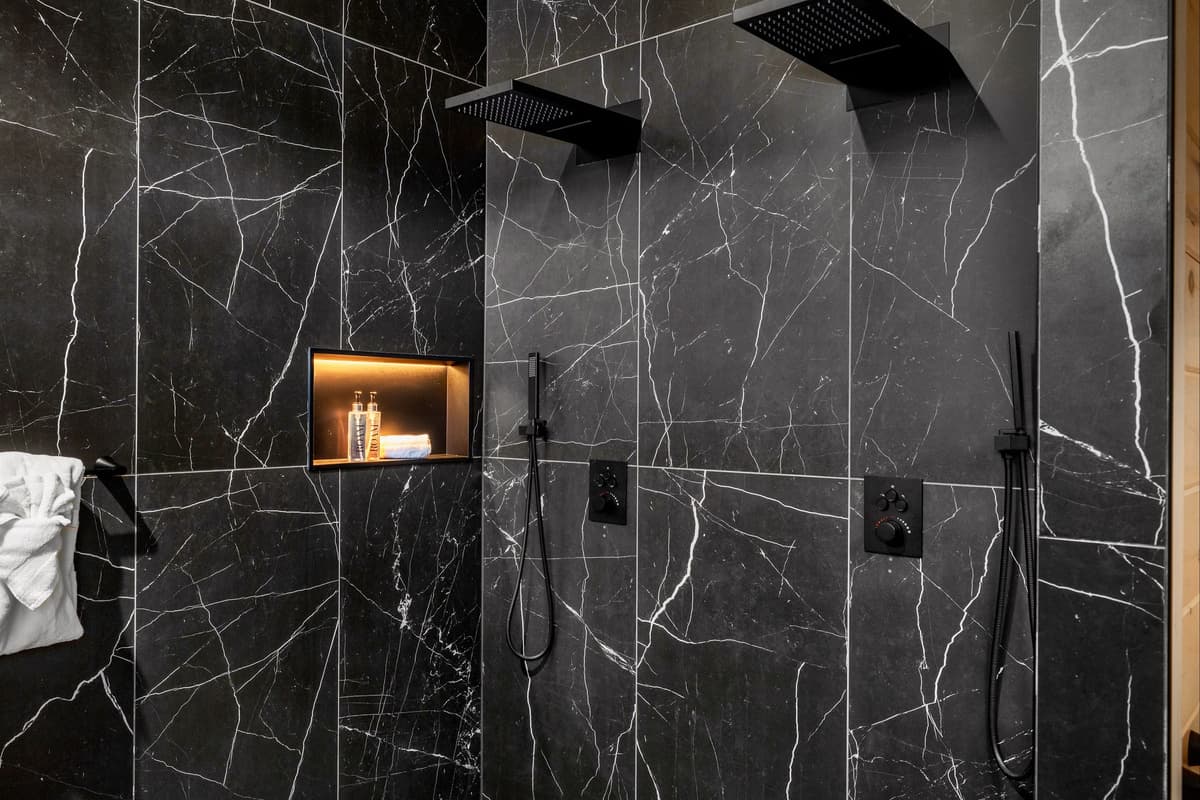 The spacious full bathroom is designed with convenience in mind, featuring two showers so guests can easily get ready without waiting.