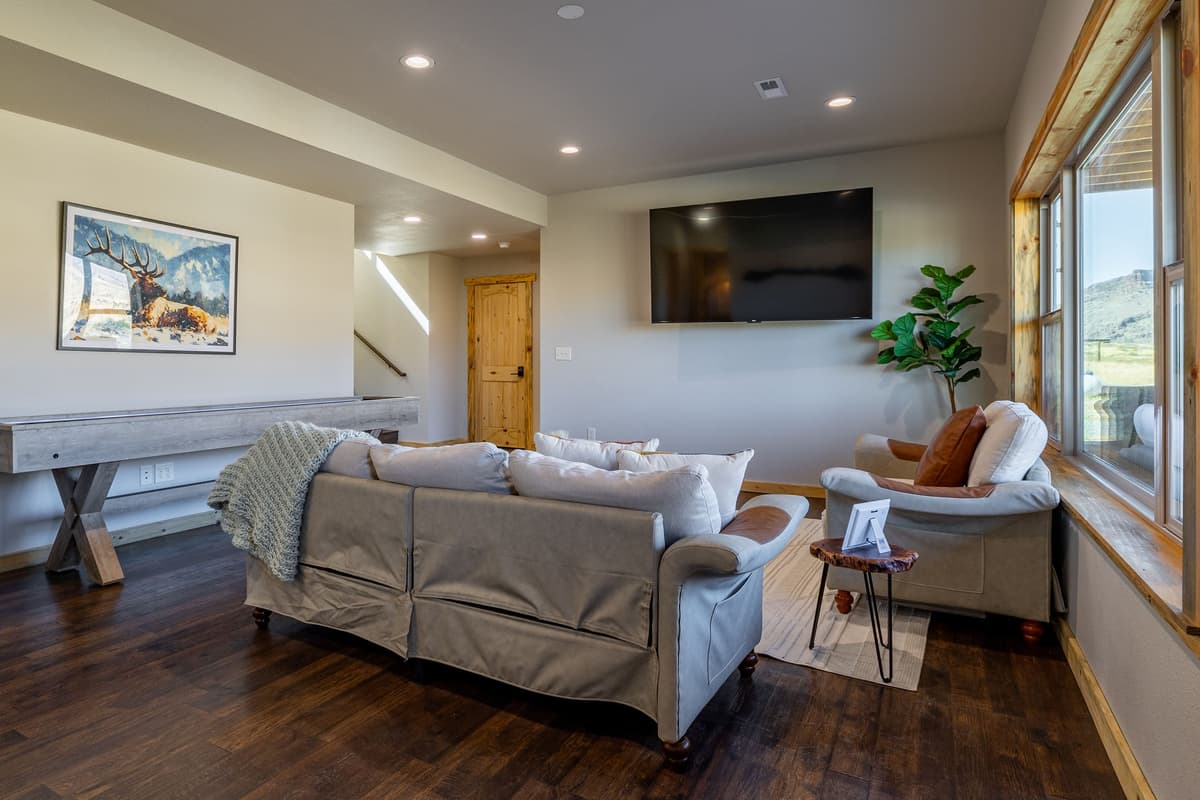 Head downstairs to the lower-level TV room, where relaxation and fun come together.