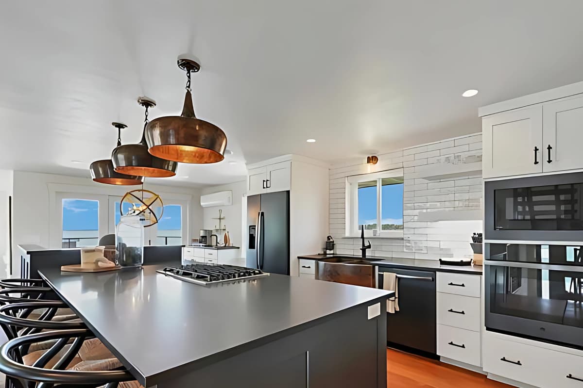 Cook and gather in the inviting kitchen, featuring modern stainless steel appliances and plenty of space for meal preparation.