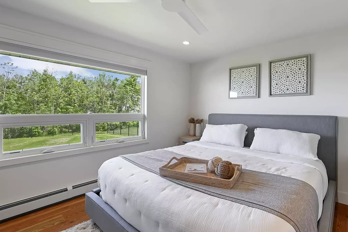 This inviting king bedroom offers a comfortable retreat for guests looking to relax and recharge. The spacious king-size bed provides plenty of room to stretch out and enjoy a restful night’s sleep.