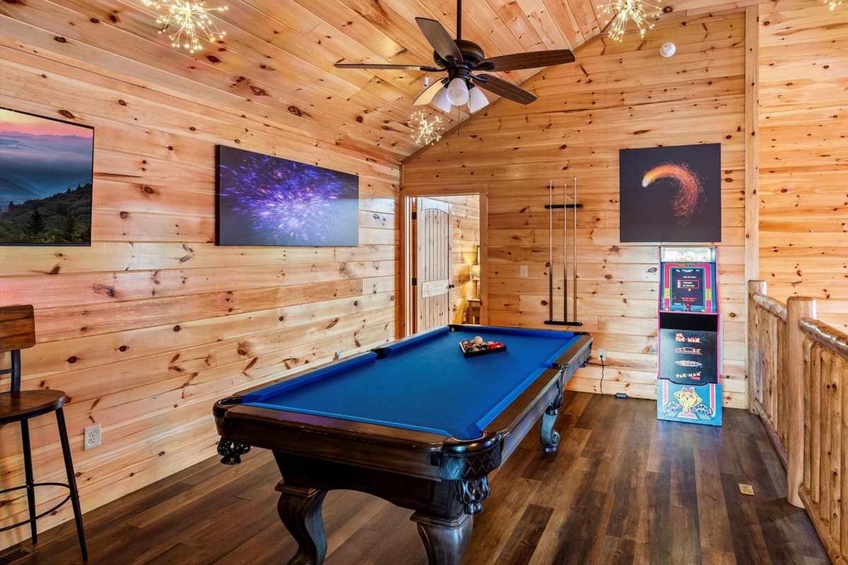 Take the fun upstairs to the cabin’s inviting game room! The pool table is ready for friendly matches and plenty of competition.