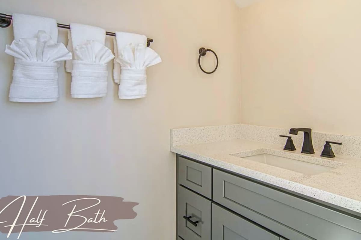 A convenient half bathroom is located nearby, making it easy for guests to freshen up without needing to head downstairs.