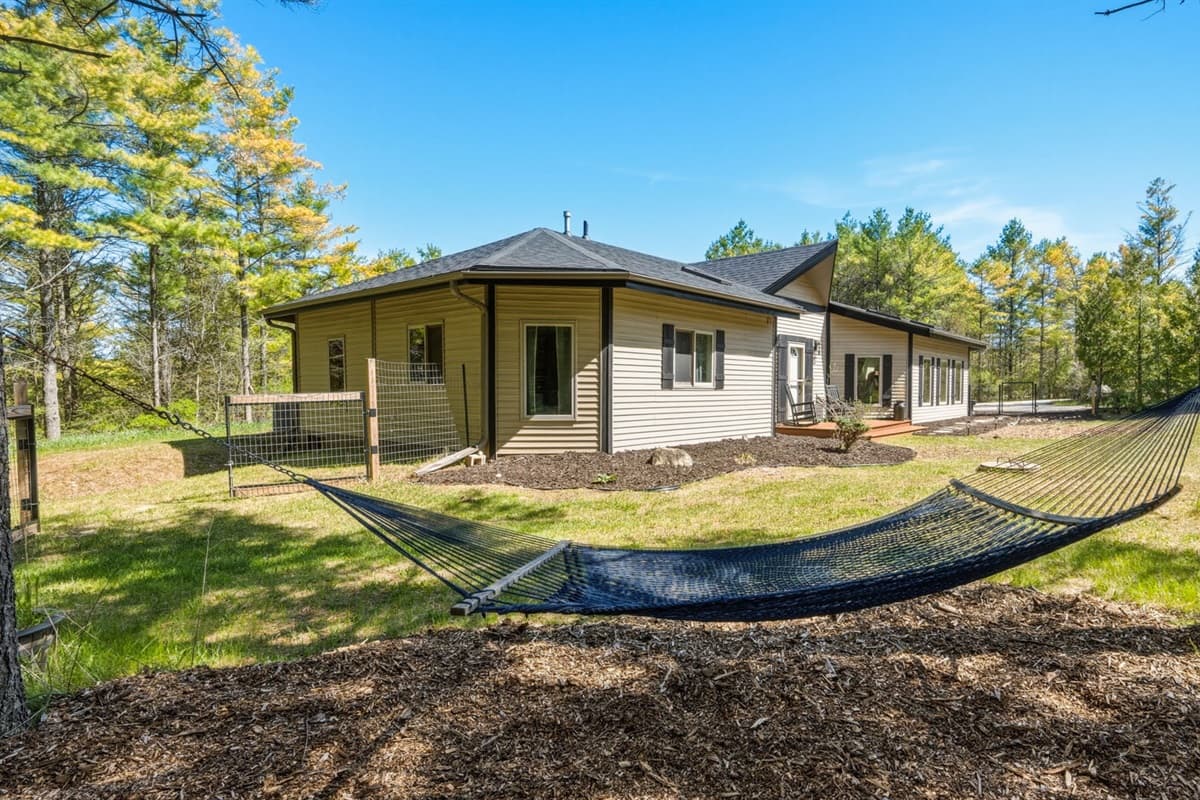 Hammock nestled beneath shaded trees, creating a peaceful spot to relax, read, or simply unwind in the fresh air.