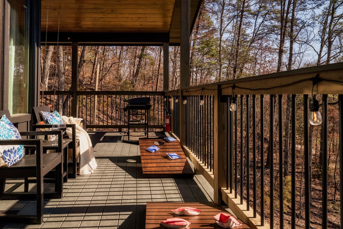 The spacious porch is made for enjoying time together. Kick back in the comfortable seating, take in the peaceful views, and enjoy a game of cornhole with family or friends.