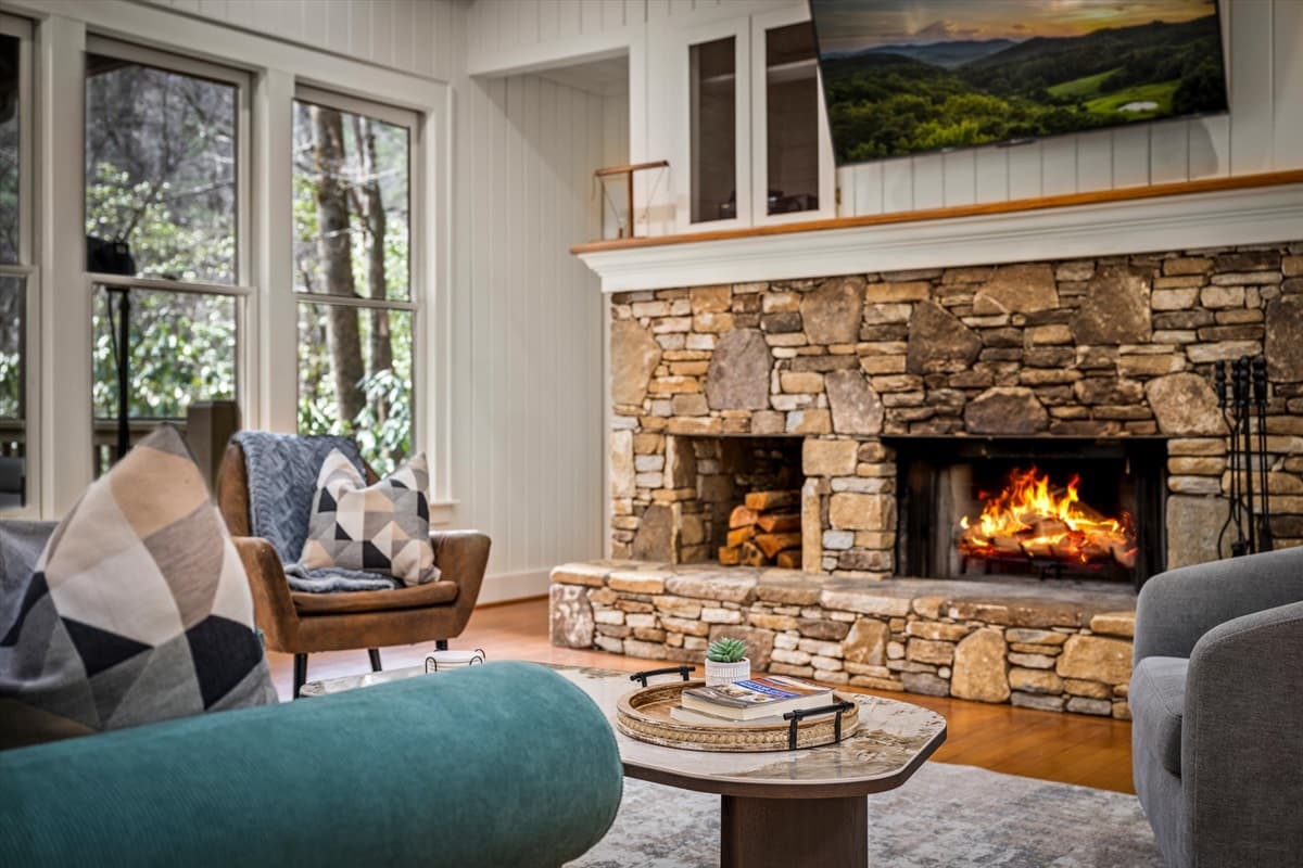 Cozy Living Room with Stone Wood-Burning Fireplace and Comfortable Seating