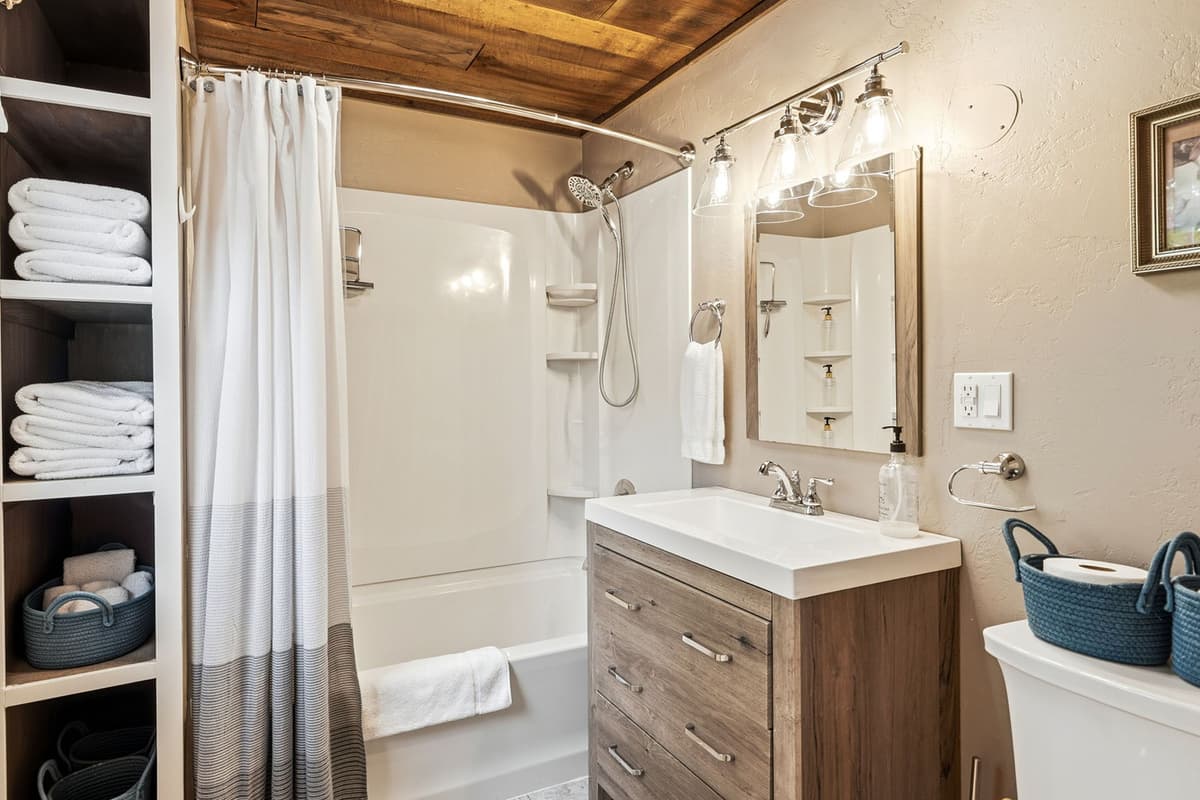 The upstairs bathroom features a convenient combination tub and shower, giving guests the flexibility to enjoy a quick shower or a relaxing soak.