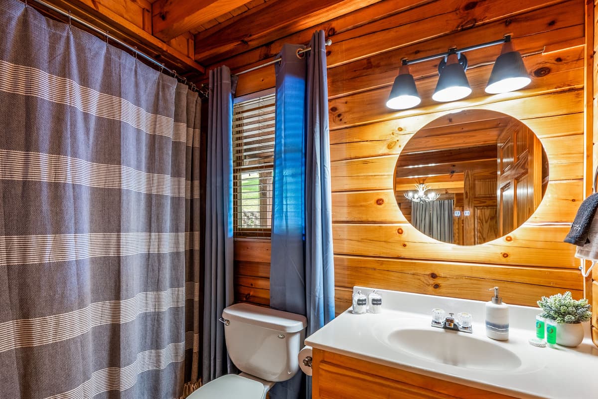 A beautiful bathroom can make a cozy cabin stay feel even more special. This inviting space is designed with comfort and relaxation in mind.