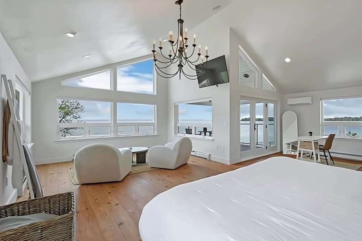 Enjoy stunning lake views from the comfort of the spacious master suite. Large windows showcase the beautiful water scenery while creating a bright, airy, and inviting space to relax and unwind.