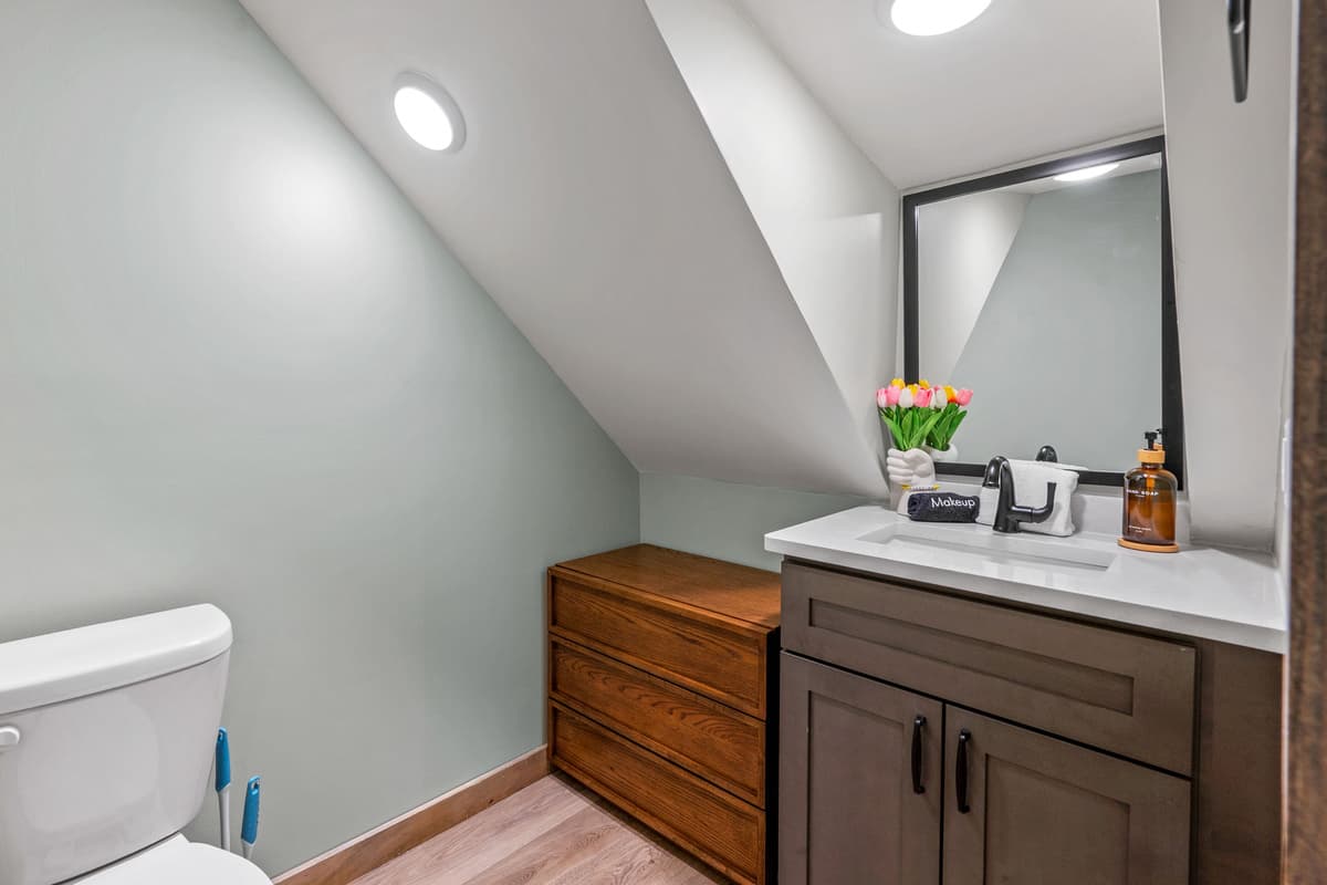 A convenient half bathroom adds an extra touch of comfort to your cabin stay. Located just off the main living spaces, it’s perfect for freshening up without having to head upstairs.
