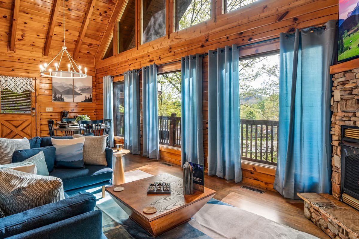 The spacious layout brings everyone together, whether you’re relaxing on the sofa, enjoying a conversation, or simply taking in the cozy cabin atmosphere.