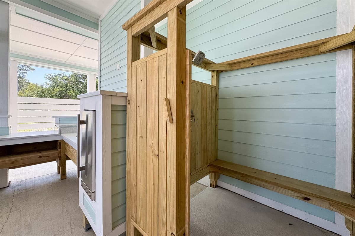 This convenient outdoor shower provides a private and refreshing rinse-off area after a day at the beach or by the pool.