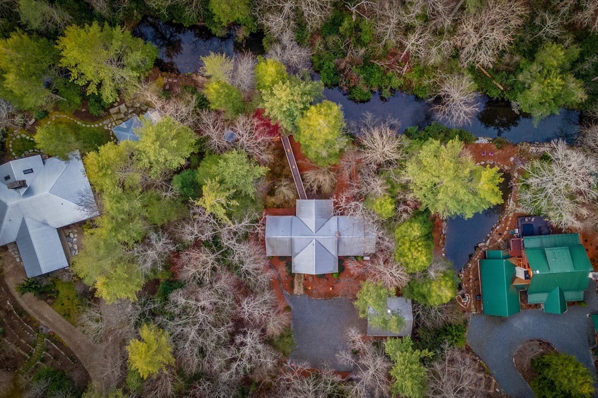 Aerial Drone View of Lost Cove Cabin Nestled Among the Treetops by the River