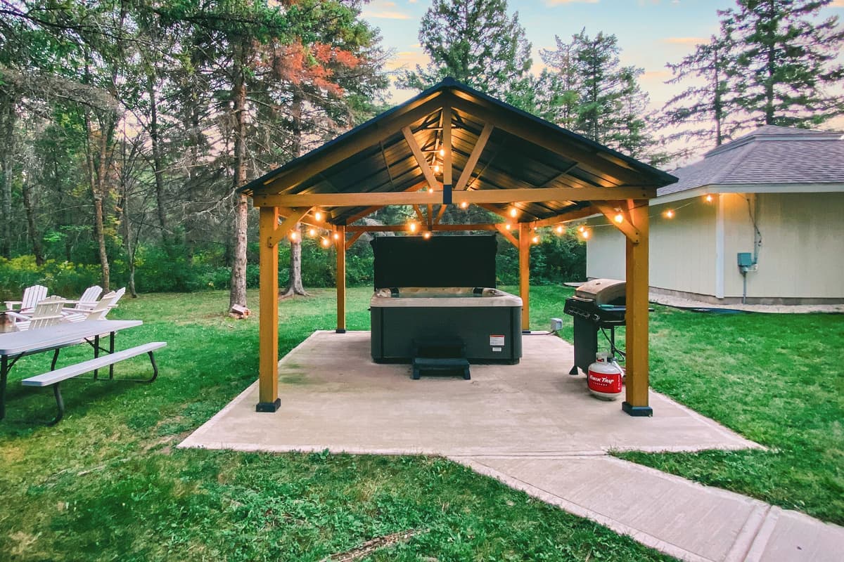 A cozy hot tub awaits just outside, ready for relaxing after a day of adventure.