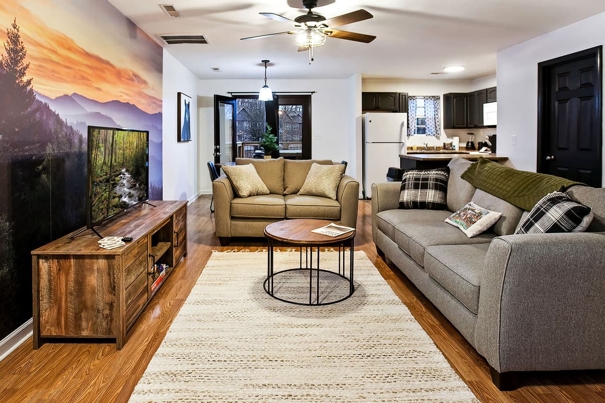 Relax in the inviting living area with a comfortable sofa and TV.