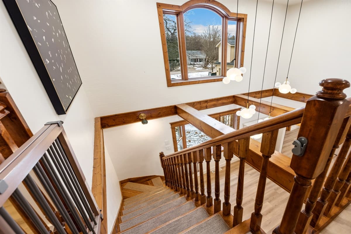 The staircase, framed by rich wood finishes adds an element of timeless elegance in this home.
