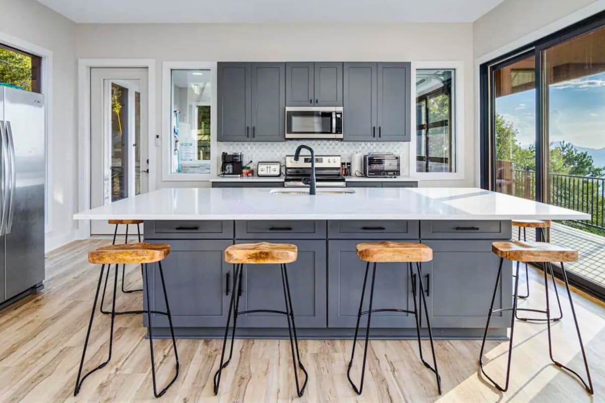 Gather around the kitchen island and enjoy casual meals from the comfortable bar chairs.