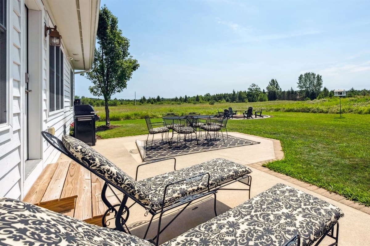 Outdoor living with dining space and loungers.