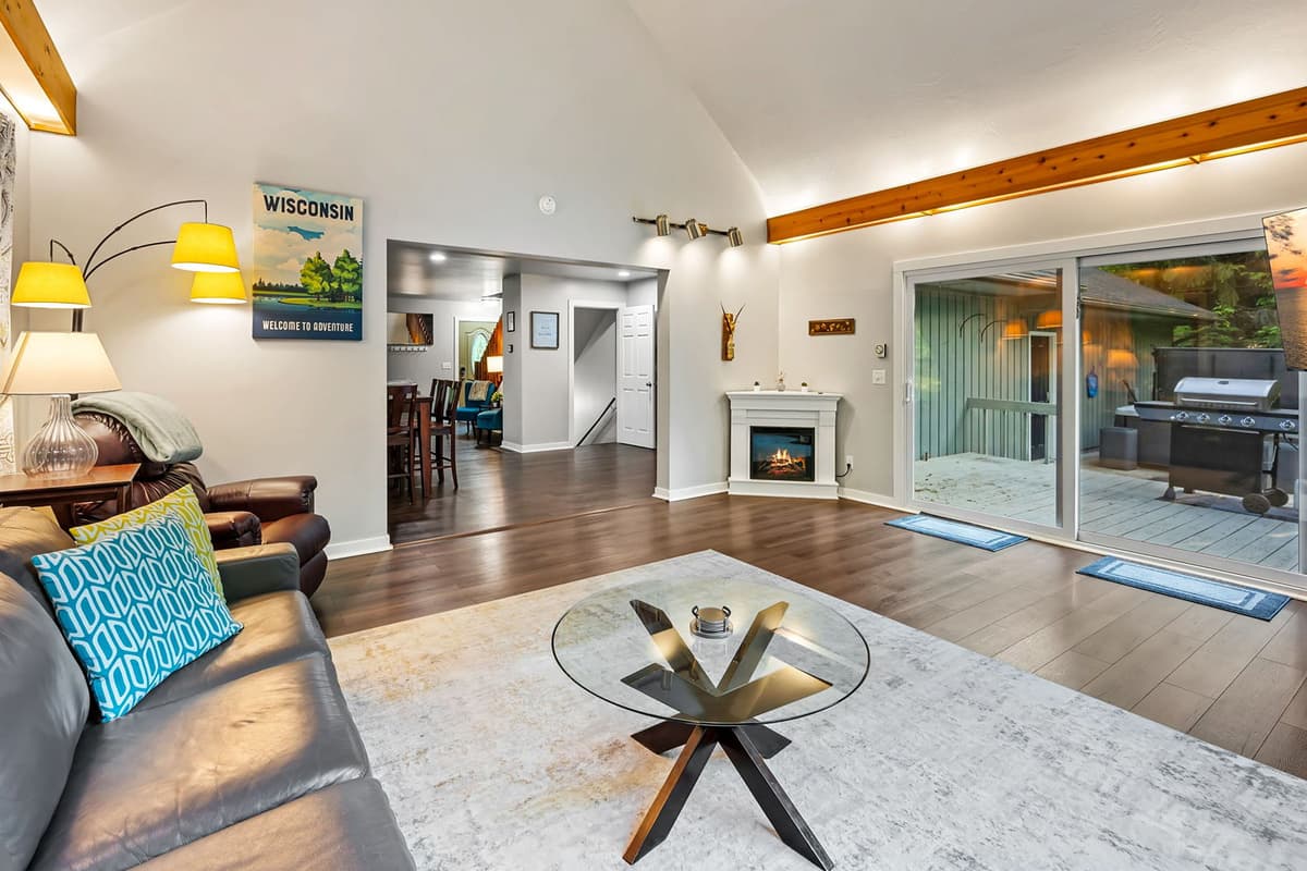 Relax in the bright and cozy sunroom with a TV and fireplace, then step directly outside onto the patio to enjoy the fresh air and peaceful surroundings.