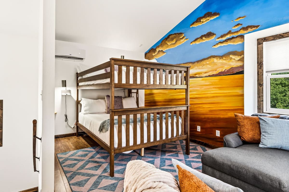 This fun and spacious bedroom features a queen-over-queen bunk bed, offering comfortable sleeping arrangements for families or groups.