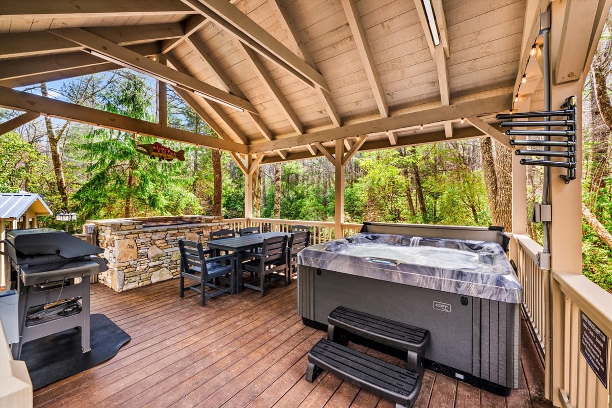 Covered Outdoor Deck with Hot Tub, Gas Grill, Outdoor Dining Area, String Lights and Hot Tub Towel Holder