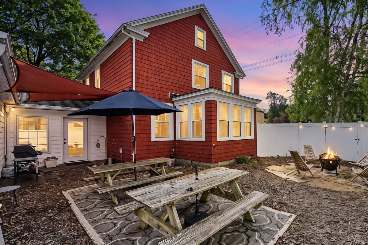 Enjoy the fresh air in the spacious outdoor area, complete with picnic tables, umbrellas, a grill, and a firepit.