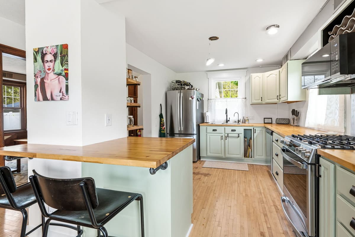The kitchen is conveniently located right next to the dining area, making it easy to serve meals and keep everyone connected while cooking.