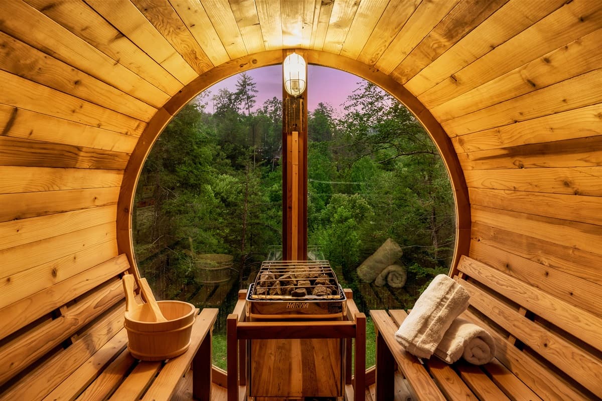 Experience ultimate relaxation in this beautifully designed barrel sauna, featuring warm wooden interiors and a cozy ambiance. It provides a perfect spot for unwinding and detoxifying amidst the natural surroundings.