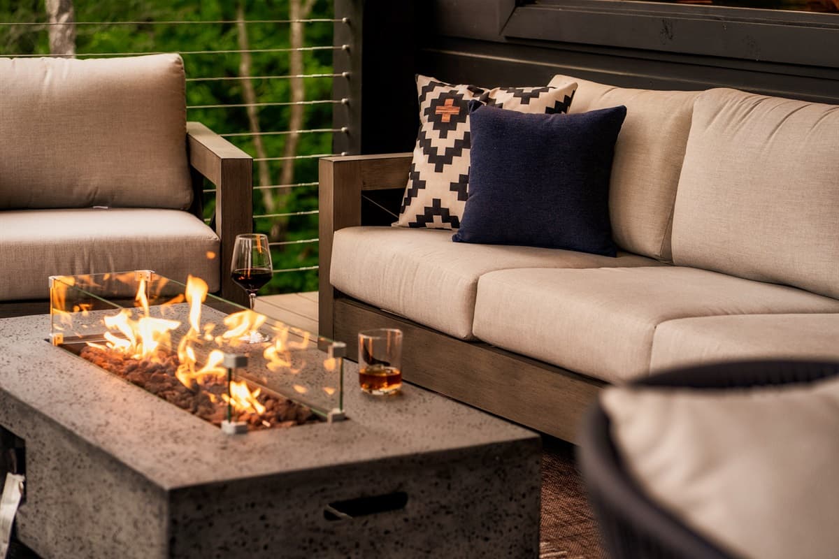 Relax by the flickering flames of this modern outdoor fire pit, surrounded by comfortable lounge seating and ready for evening drinks.