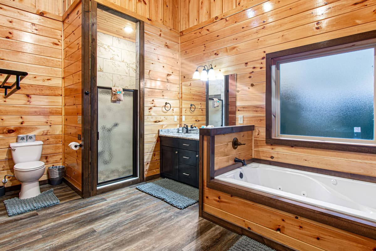 The private ensuite bathroom features both a relaxing bathtub and a spacious walk-in shower, offering guests the best of comfort and convenience.