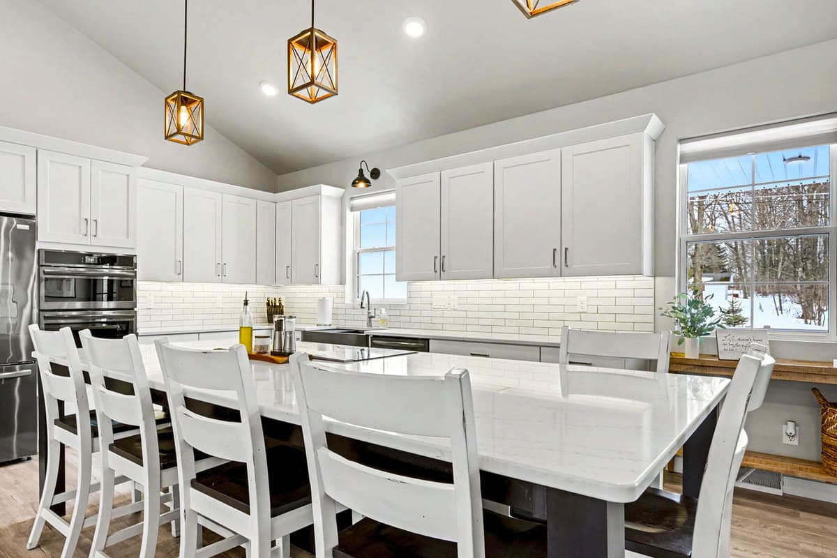 The spacious island features comfortable bar seating, making it a convenient spot for breakfast, snacks, or casual meals.