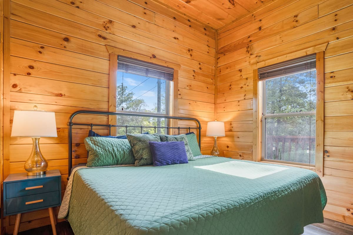 Sink into the comfort of the inviting king bedroom, featuring a spacious king-size bed dressed in fresh, cozy sheets.