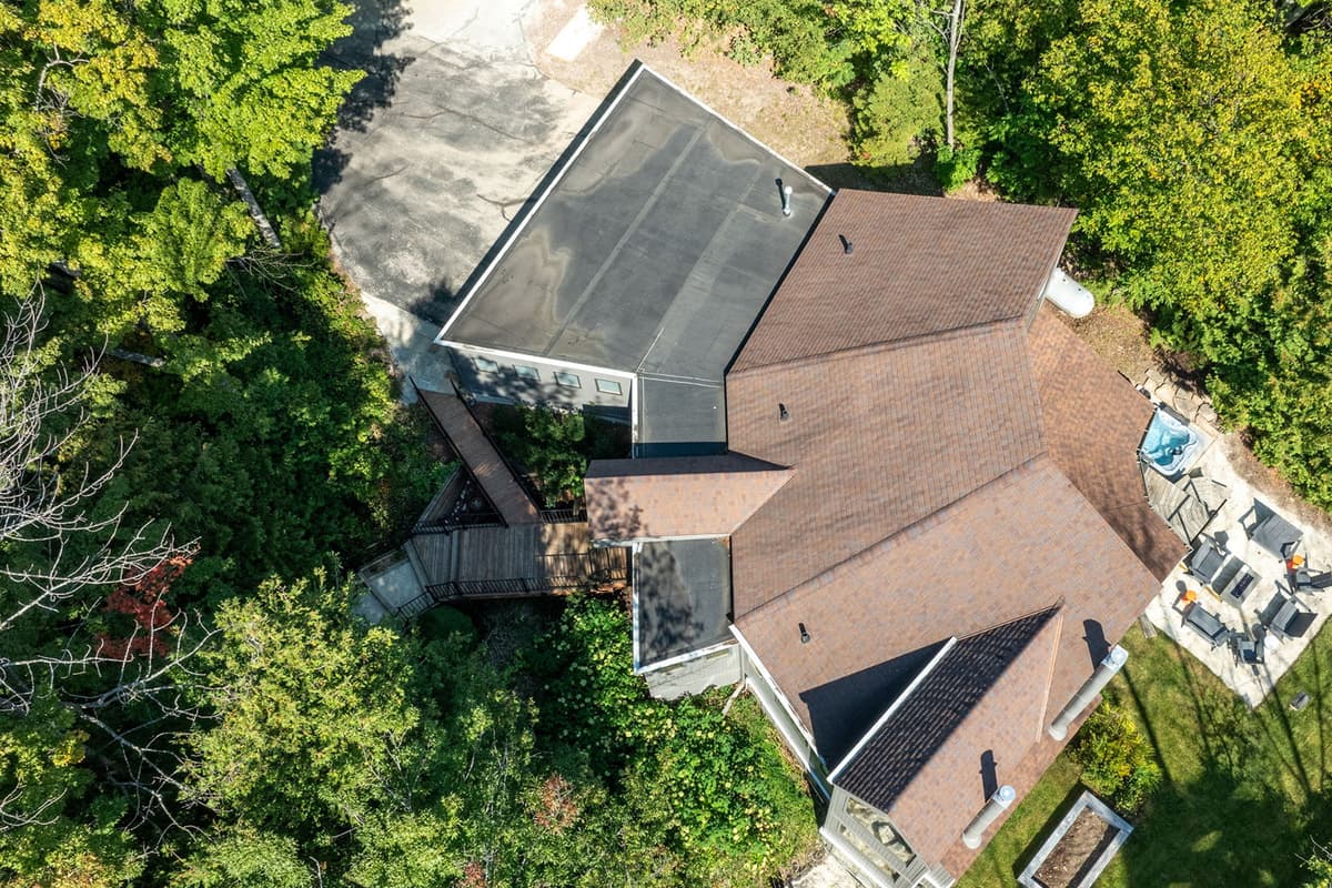 Tall trees and natural surroundings create a relaxing atmosphere around the home.