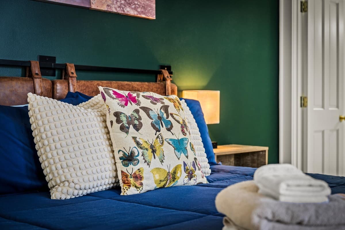 Third Bedroom with Blue Bedding, Floral Accents and Complimentary Towels