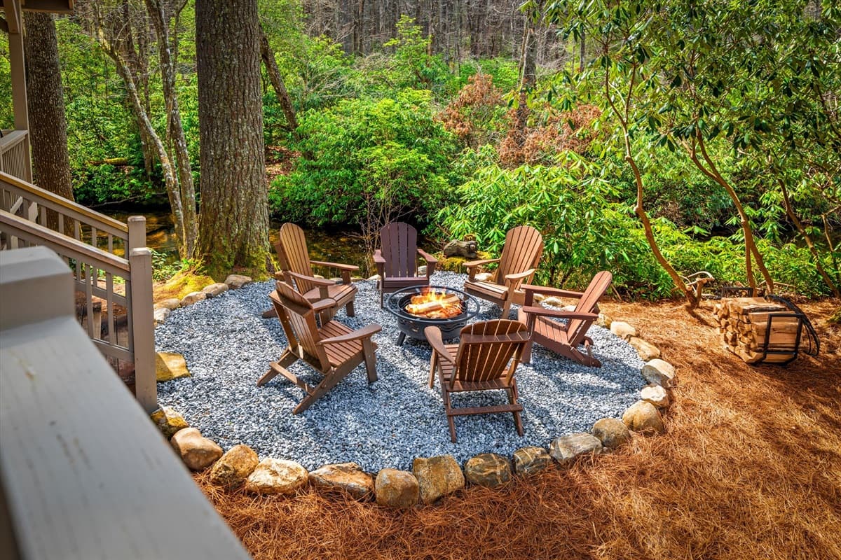 Fire Pit Seating Area Directly on the River with Adirondack Chairs and Gravel Surround