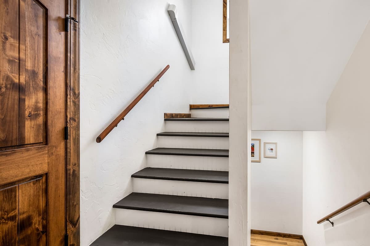 The stairs provide convenient access from the main level to the basement.