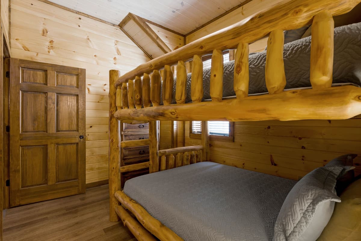 Head downstairs to discover a cozy lower-level bedroom featuring a queen-over-queen bunk bed.