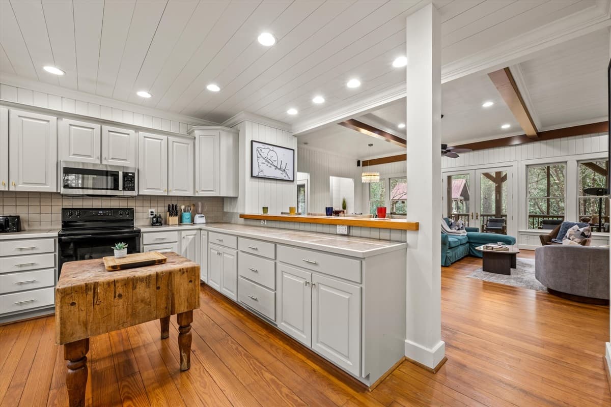 Kitchen Butcher Block Island with View Through to the Open-Concept Living Area