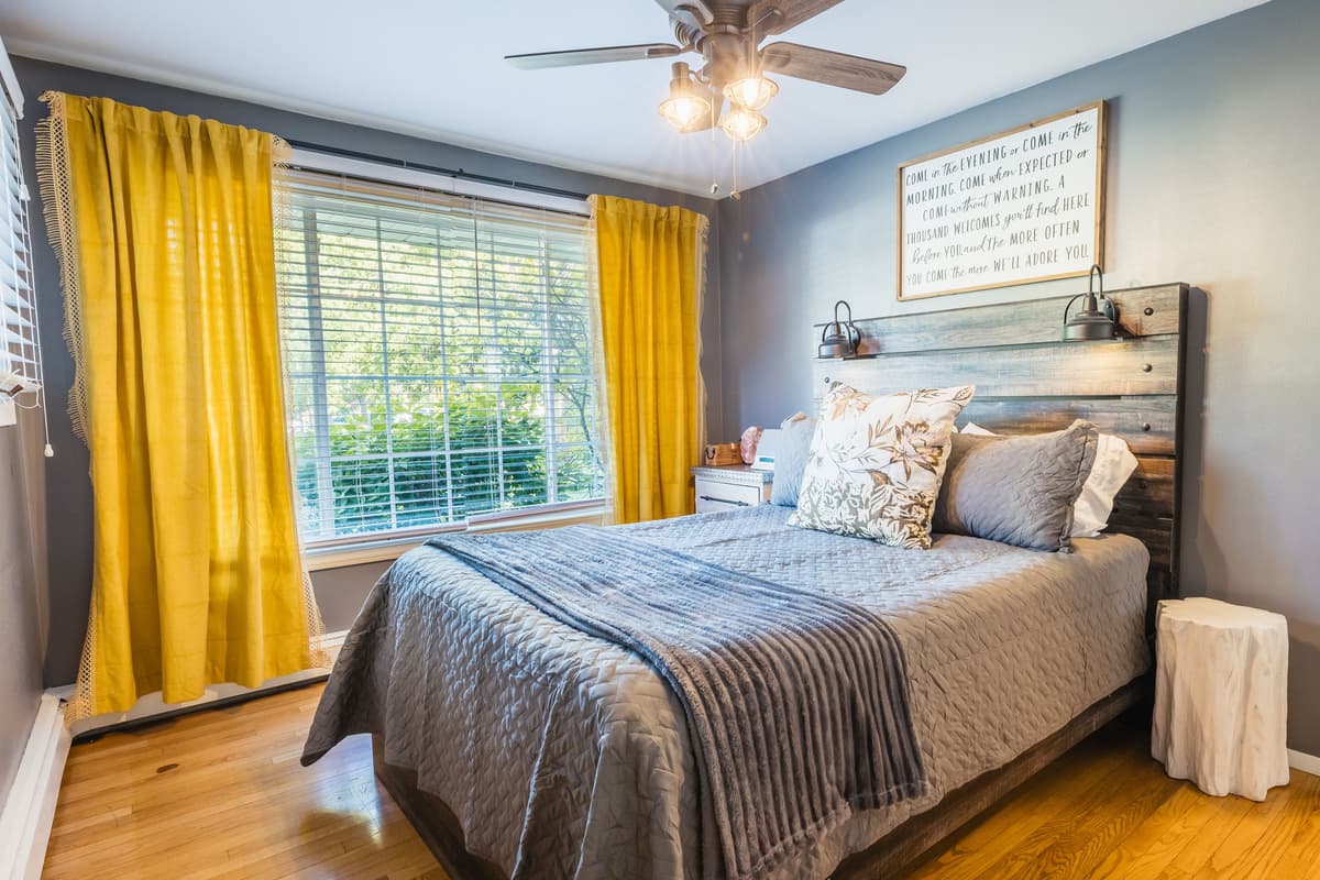 A cozy queen bed provides a comfortable place to unwind after a day of exploring Menasha. Natural light adds to the bright and comfortable feel of the space.