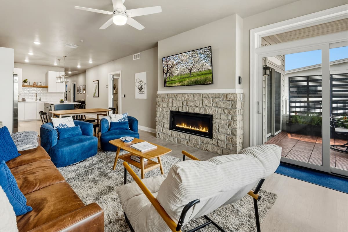 Relax in the inviting living room, featuring comfortable seating, a TV, and a cozy fireplace.