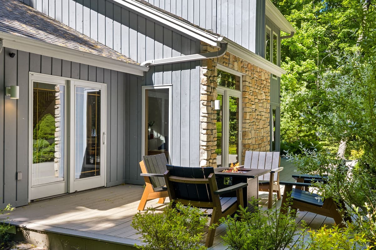 The deck features a cozy fire table, creating a welcoming spot to gather in the evening.