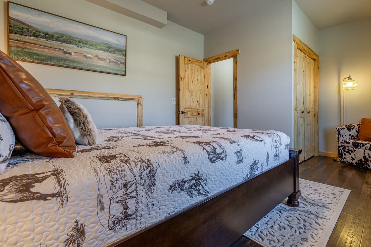 Unwind in a cozy queen bedroom designed for a peaceful night’s rest. The comfortable queen bed provides the perfect place to recharge after a day of exploring Cody, Wyoming.