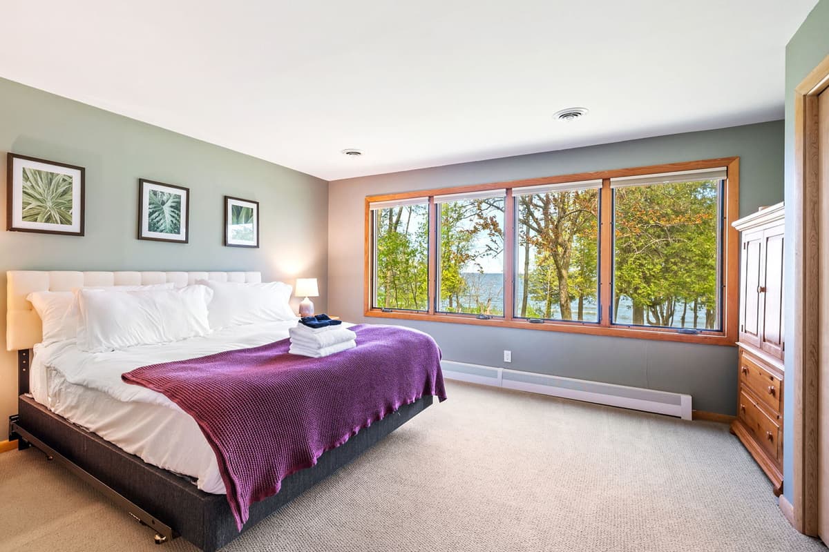This spacious king bedroom offers a comfortable and relaxing retreat for a restful stay. T