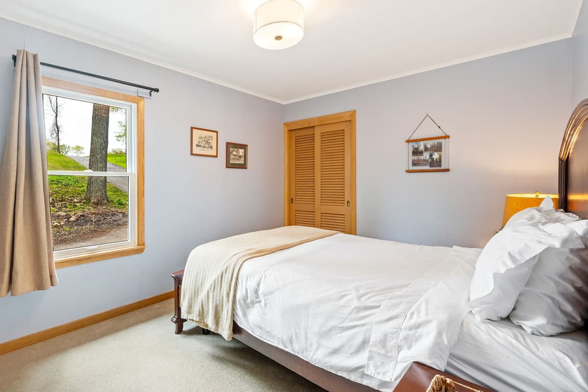 This welcoming queen bedroom offers a comfortable space to relax and recharge during your stay.