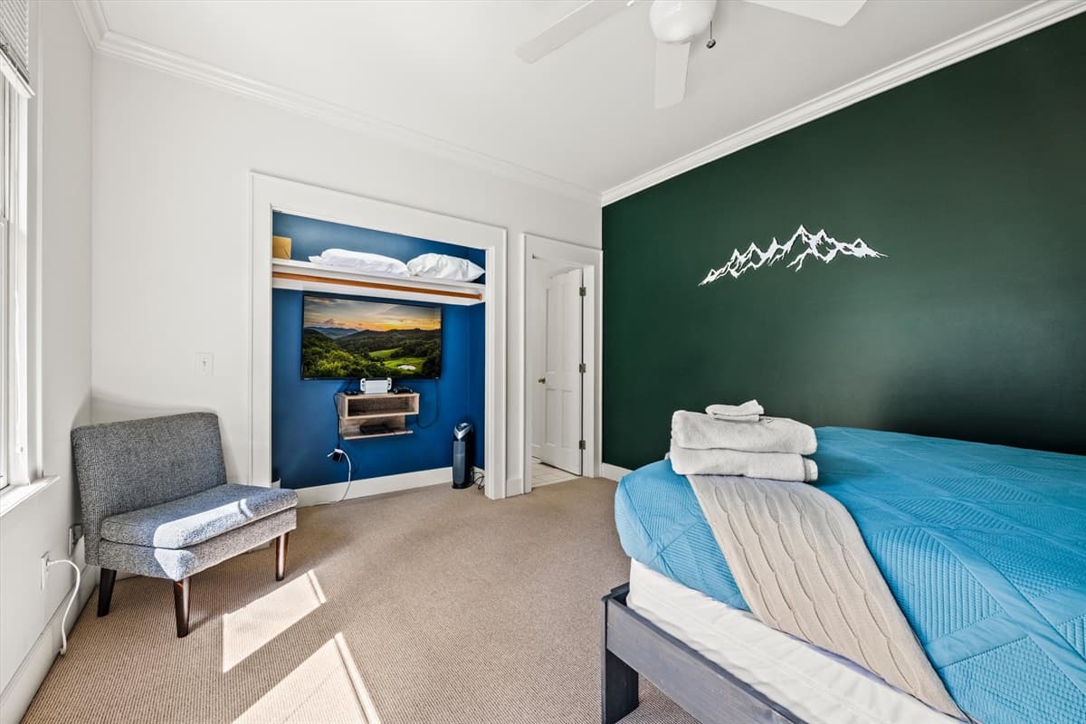 Second Bedroom Bunk Bed with Teal Bedding, Mountain Decal on Dark Green Accent Wall