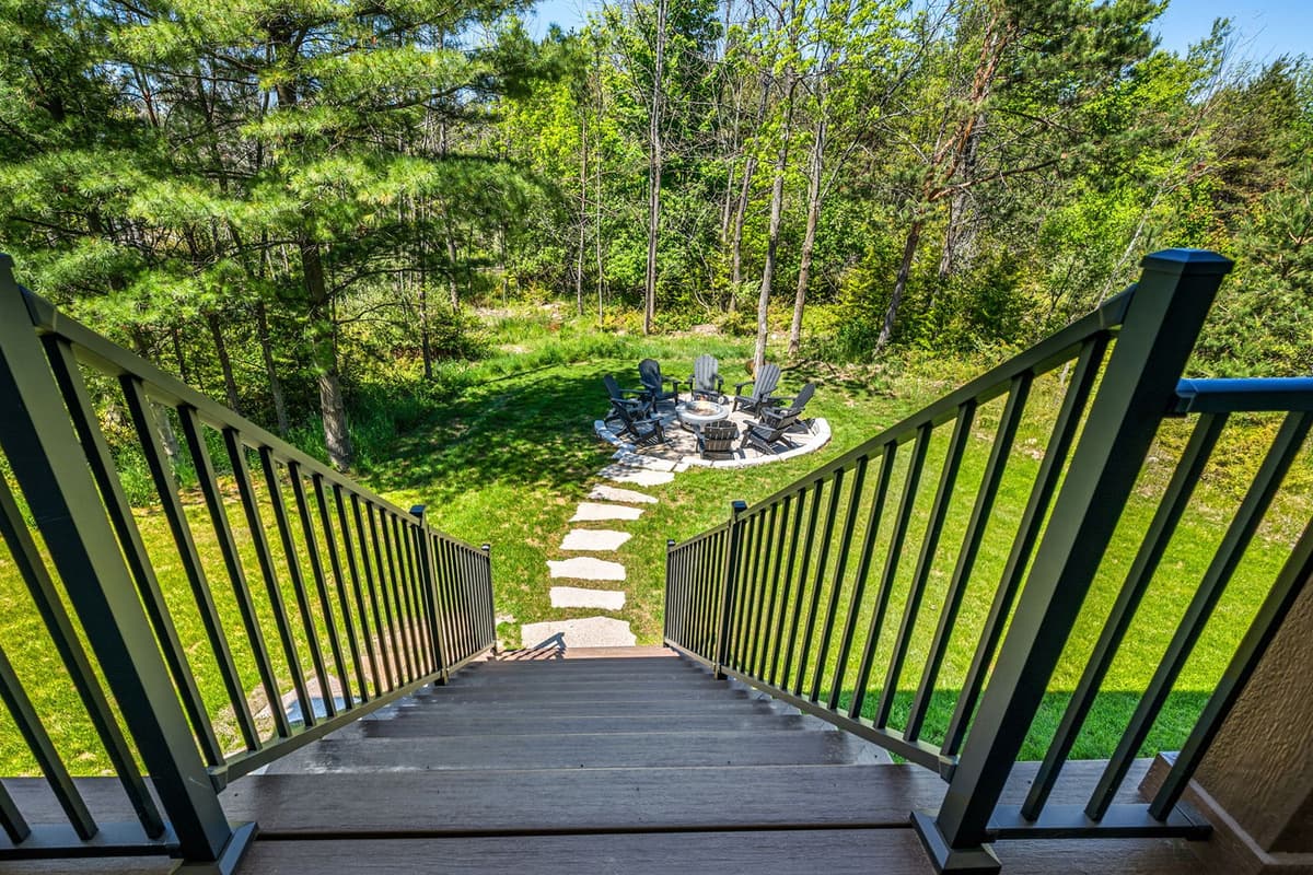 The firepit is conveniently located along the steps leading down toward the hot tub.
